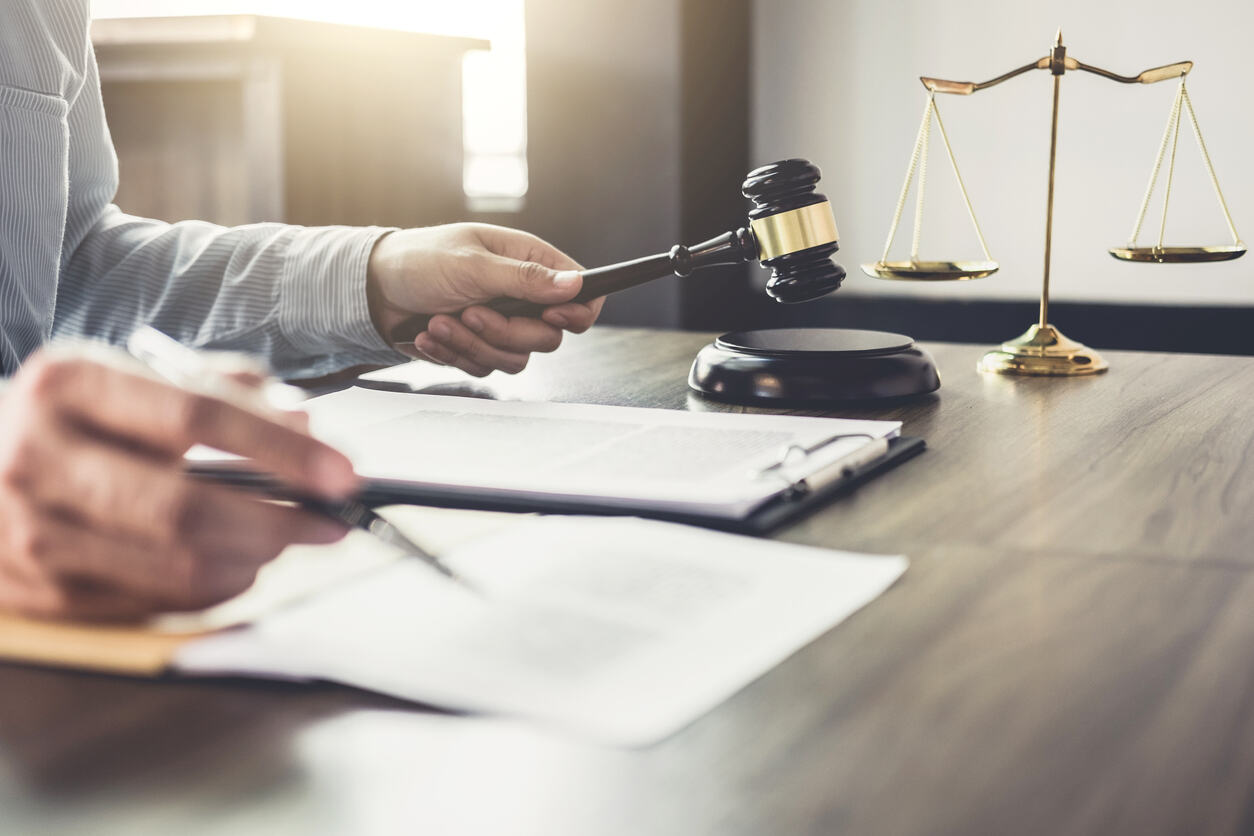 Northglenn personal injury lawyer writing and holding gavel