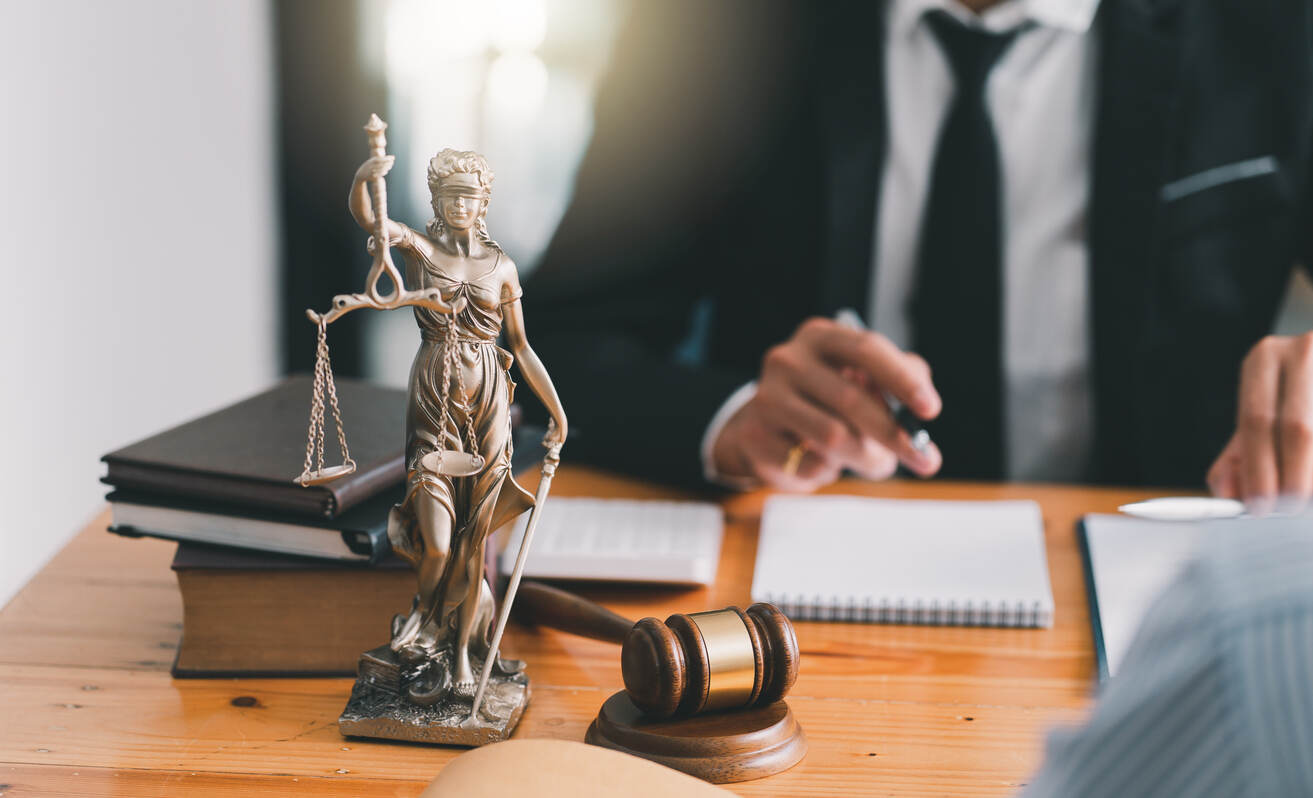 Brighton Personal Injury Lawyer is sitting on the table with pen,paper and gavel 