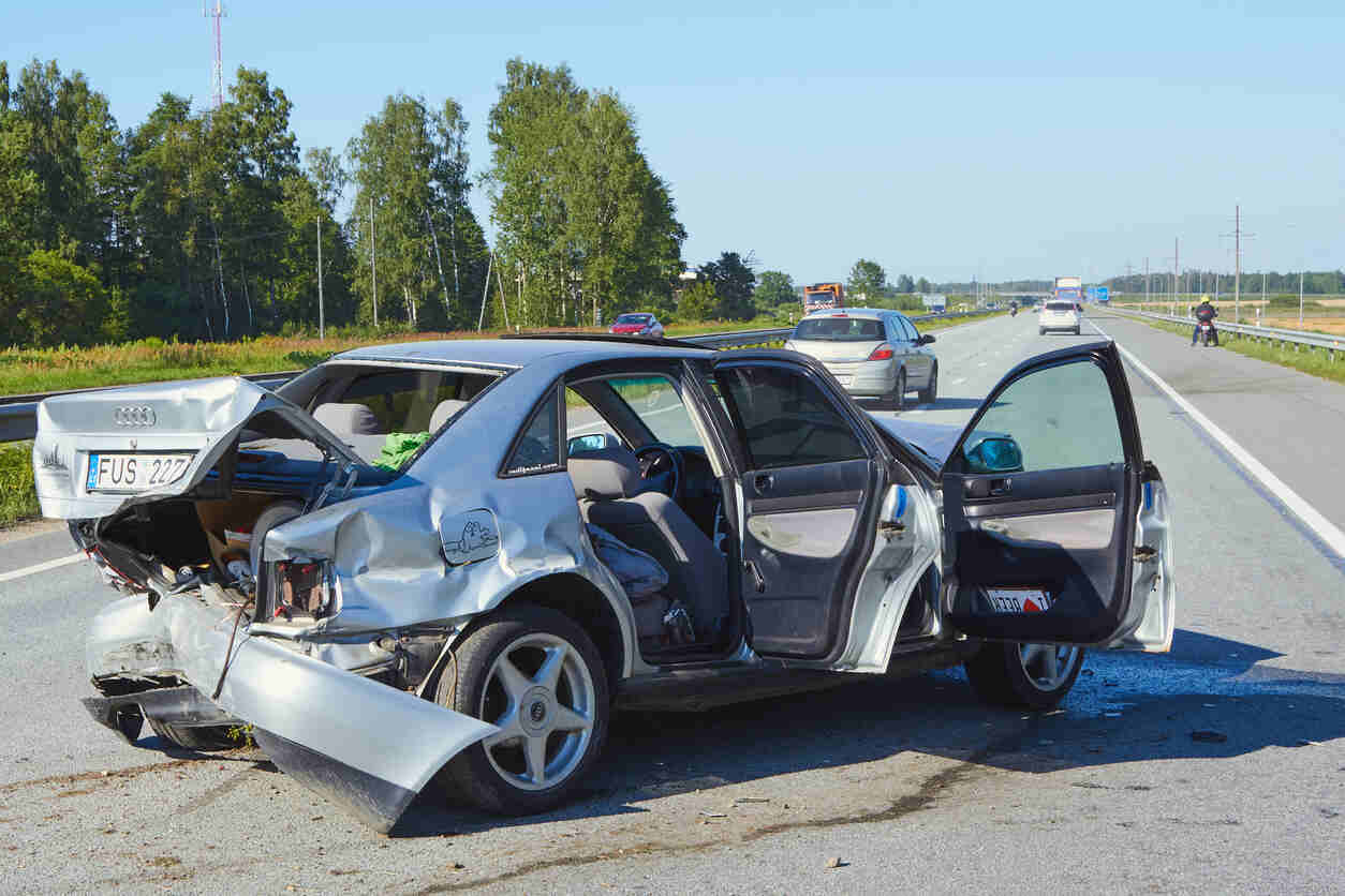 blue car accident on the Colorado Springs highway , indicating a need for a car accident attorney.