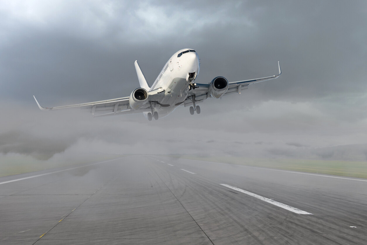 Commercial jet approaching a runway in stormy weather, representing a potential aviation accident scenario.